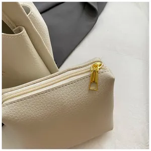 Korean style minimalist textured PU leather bucket bag detail close-up view with a chic pouch.