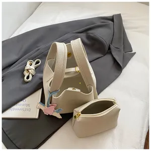 Korean style PU leather bucket bag set with matching pouch and stylish strap for daily wear.