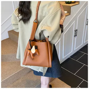 Korean style retro brown leather bucket bag with cute horse charm, chic shoulder handbag.