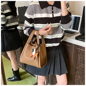 Korean-style retro bucket bag with cute horse charm, chic leather handbag for women daily wear.