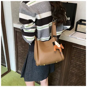 Korean retro style PU leather bucket bag with cute horse charm, casual shoulder tote handbag.