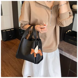 Chic black bucket bag featuring a cute winged horse charm, stylish daily handbag for women.