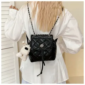 Autumn trendy quilted chain backpack, black fashion mini shoulder bag with cute bear pendant.