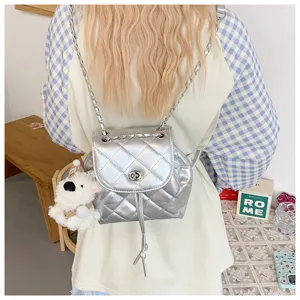 Silver quilted mini backpack for women, stylish chain strap small shoulder bag for autumn fashion.