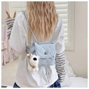 Light blue quilted mini backpack detail showing chain strap and cute dog pendant accessory.