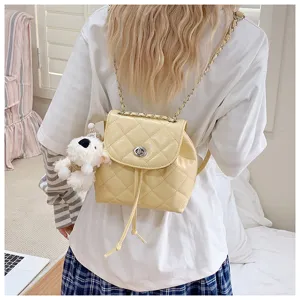 Quilted mini backpack with elegant chain straps and cute dog pendant for chic daily style.