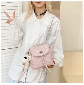 Detailed view of a pink quilted chain backpack with dog charm and Korean ins style.