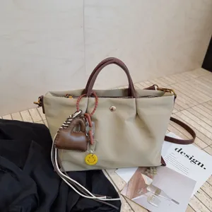 Stylish nylon crossbody bag for women, large capacity casual tote bag with cute charms.