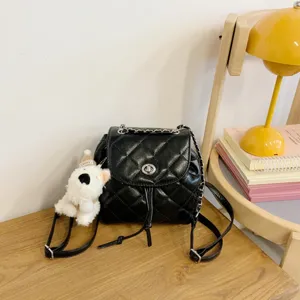 Black quilted leather chain backpack for women, stylish small travel rucksack with cute puppy pendant.