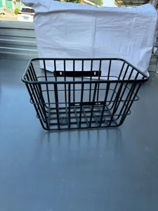 Universal black metal wire basket for electric bicycles and rear racks, sturdy and durable design.