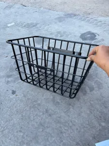 Black metal electric bicycle rear storage basket, sturdy wire mesh basket for daily use.