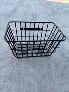 Detailed view of the black metal wire basket for electric bike, sturdy grid design structure.