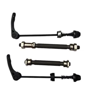 Close-up detail of bicycle quick release skewers and hollow axle components for bike wheels.