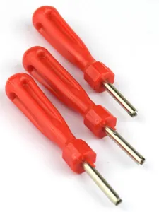 Close-up of red plastic handle tire valve core screwdriver and repair tool detail.