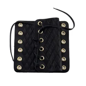 Black leather motorcycle handlebar cover detail with diamond pattern and metal eyelets.