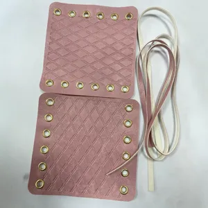 Pink quilted leather handlebar covers with gold metal eyelets and straps for bike