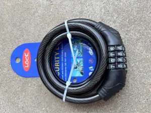Close-up detail of a 4-digit bicycle steel cable lock securely coiled on blue packaging card.