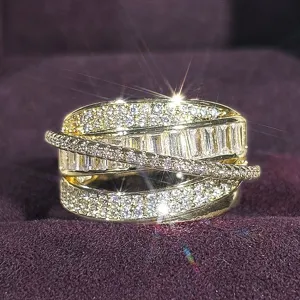 Luxury wide crossover statement ring with sparkling baguette and pavé zirconia stones.