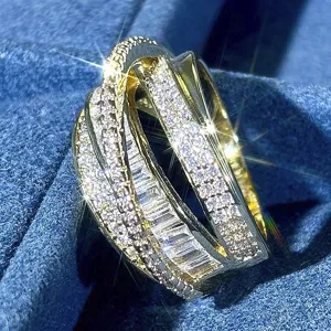Detail shot of a stunning multi-band gold ring, heavily paved with sparkling crystal stones.