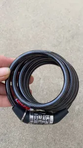 Detailed view of a four-digit bicycle combination coil lock with durable steel wire and secure dial.