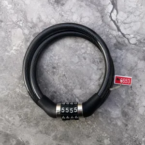 Detail view of the black bicycle combination lock, showing 4-digit wheel and steel cable.