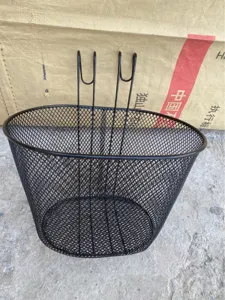 Black metal wire mesh bicycle front hanging basket detail view, sturdy handlebar design.