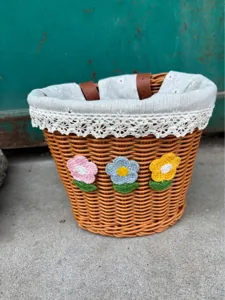 Close-up details of the woven bicycle basket featuring cute crochet flowers and lace lining.