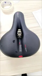 Detailed view of black ergonomic bicycle saddle with hollow breathable ventilation zone.