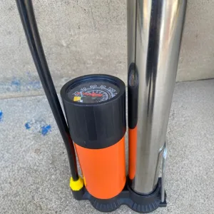 Pompa per bici ad alta pressione portatile con manometro, cilindro in metallo e base arancione.