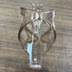 Translucent brown plastic bicycle water bottle cage detail view, sturdy cycling accessory.