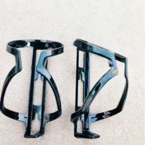 Black plastic bicycle water bottle cage mount for road and mountain bike cycling gear.