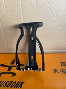Detailed view of a black plastic bicycle water bottle cage, lightweight design for cycling.