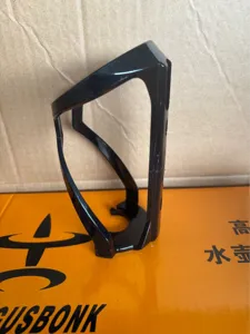 Black plastic bicycle water bottle cage, durable cycling cup holder accessory for bikes.