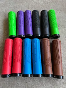 Detailed view of colorful mountain bike handlebar grips featuring anti-slip texture and locking rings.