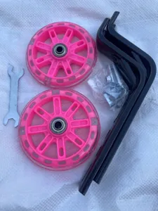 Children bicycle training wheels set with flashing pink wheels, brackets and wrench.