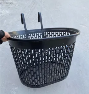 Black plastic bicycle front basket detail showing mounting hooks and mesh design.