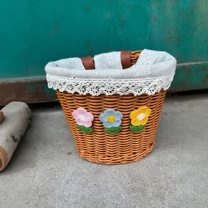 Floral woven bicycle basket with cloth liner and cute crochet flowers for storage.