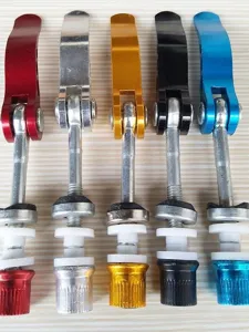 Detailed view of colorful aluminum alloy mountain bike seat post quick release levers.