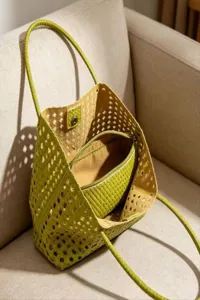 Green woven cutout tote bag detail view showcasing texture and inner zippered pouch