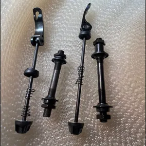 Detailed view of bicycle quick release skewers and hollow axle components for bike maintenance.