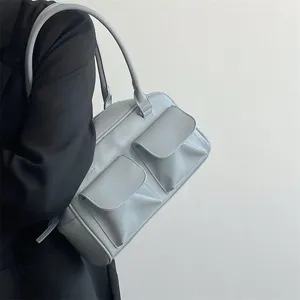 Minimalist underarm shoulder bag for women, retro commuter tote with dual front pockets, stylish.