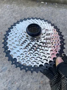 Detail view of mountain bike cassette gear showing metallic teeth structure and finish.