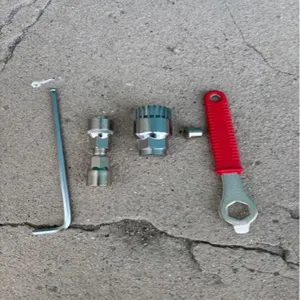 Bicycle bottom bracket removal tool set detail shot, metal crank puller and repair wrenches.
