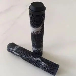 Detail view of black and white mountain bike handlebar grips with anti-slip texture.