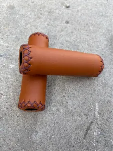 Brown PU leather bicycle handlebar grips, vintage hand-stitched design for folding road bikes.