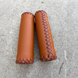 Vintage bicycle handlebar grips, brown PU leather hand-stitched design, soft surface for road bikes.