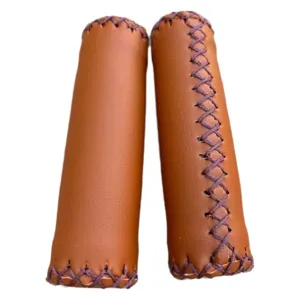 Vintage brown PU leather bicycle handlebar grips with hand-stitched cross lace design for bikes.