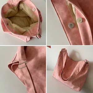 Pink slouchy tote bag detail view showing interior lining, zipper pocket, and magnetic snap.