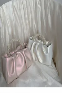 Chic pleated mini cloud handbag with pearl handle, trendy casual women crossbody bag detail.