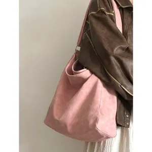 Detailed view of large capacity pink slouchy shoulder tote bag for daily commute and study.